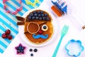 Fun food for kids. Cute pirate pancakes with blueberry. Creative idea for children breakfast.