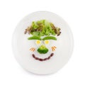 Fun food for kids - cute smiling clown face on salad decorated with fresh carrots,Lotus root,green peas,Ginkgo,Red bean;Quail eggs Royalty Free Stock Photo