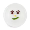 Fun food for kids - cute smiling clown face on salad decorated with fresh carrots,Lotus root,green peas,Ginkgo,Red bean;Quail eggs Royalty Free Stock Photo