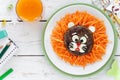 Cute lion shaped burger with fresh carrots for kids