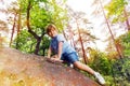 Fun in the forest boy climbs on small stone Royalty Free Stock Photo