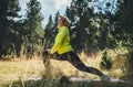 Fun girl exercising outdoors in green park, activity with stretch legs. Smile fitness woman doing stretching exercises training Royalty Free Stock Photo