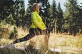 Fun girl exercising outdoors in green park sun summer day, activity with stretch legs. Smile fitness woman stretching exercises Royalty Free Stock Photo