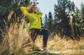 Fun girl exercising outdoors in sun summer day, activity with stretch legs in park. Smile fitness woman stretching exercises train Royalty Free Stock Photo