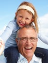 Fun with. A granddad carrying his granddaughter on his shoulders. Royalty Free Stock Photo