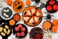 Fun Halloween dinner party table scene over a white wood background