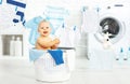 Fun happy baby boy to wash clothes and laughs in laundry Royalty Free Stock Photo