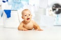 Fun happy baby boy to wash clothes and laughs in laundry Royalty Free Stock Photo