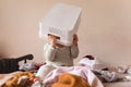 Fun happy baby toddler with laundry basket on head and piles around him Royalty Free Stock Photo