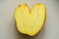 Fun heart shape potato on bright background Royalty Free Stock Photo