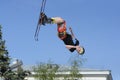 Fun jumping, skiing. Young boy, the skier, doing somersaults high in the blue sky with skis Royalty Free Stock Photo