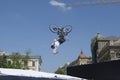 Fun jumping. Young boy, the cycler, soaring high in the blue sky with the bike Royalty Free Stock Photo