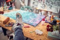 Fun leisure.artist sitting and feet dirty with multicolor paint