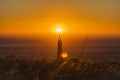 Silhouette of a beautiful woman standing and praying at sunset or sunrise.