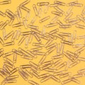 Fun lively design of paperclips on bright yellow background