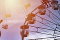 Fun in the lunapark, people on the rollercoaster and big wheel, susnet Royalty Free Stock Photo