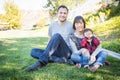 Fun Mixed Race Family Having Fun Outside on the Grass Royalty Free Stock Photo