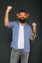 Only fun on my mind. Entertaining himself. Bearded man wearing party glasses. Funny hipster in extravagant glasses