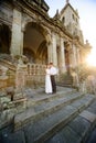 Fun newly married couple embrace near the Church Royalty Free Stock Photo