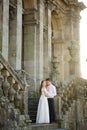 Fun newly married couple embrace near the Church Royalty Free Stock Photo