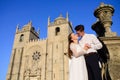 Fun newly married couple embrace near the Church Royalty Free Stock Photo