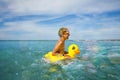 Fun at ocean - boy in sunglasses swim with inflatable duck Royalty Free Stock Photo