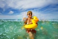 Fun in ocean - boy with sunglasses and yellow inflatable duck Royalty Free Stock Photo
