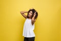 Fun and People Concept - Headshot Portrait of happy Alfo African American woman with freckles smiling and showing rabbit Royalty Free Stock Photo