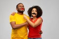 Happy african american couple with party props