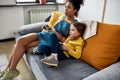 Fun and play all day. African american woman, baby sitter and caucasian cute little girl having fun together, playing Royalty Free Stock Photo