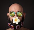 Unshaven man with beard with flowers and sunglasses on dark background Royalty Free Stock Photo