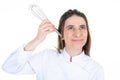 Fun portrait chef woman with hand beater utensil on white background