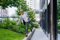 Fun portrait of happy energetic mature businessman with arms outstretched balancing on wall , feeling free, work life Royalty Free Stock Photo