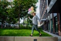 Fun portrait of happy energetic mature businessman holding balloons and walking on wall , feeling free, work life Royalty Free Stock Photo