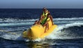 Fun riding banana boat. Royalty Free Stock Photo