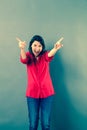 Fun 30s woman shouting with extrovert hand gesture