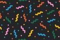Fun seamless pattern with colorful confetti on black backdrop. Multi colored abstract festive background. Pop art style Royalty Free Stock Photo