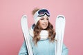 Fun skier is preparing to ski. Young woman in equipment and with skis, Royalty Free Stock Photo