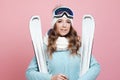 Fun skier is preparing to ski. Young woman in equipment and with skis, Royalty Free Stock Photo