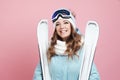 Fun skier is preparing to ski. Young woman in equipment and with skis, Royalty Free Stock Photo