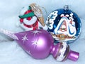 A fun snowman, a glass ball and a Christmas tree top. Festive background. Holiday card. Symbols of the New year and Christmas.