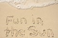 Fun in the Sun Written in Sand on Beach Royalty Free Stock Photo