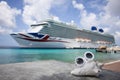 Sunglasses on a big seashell on seascape with cruise liner background. Selective focus.