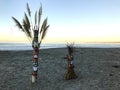 Tikis on the beach at sunrise