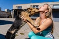 Fun time. Girl playing with her dog in the street Royalty Free Stock Photo