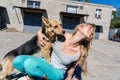 Fun time. Girl playing with her dog in the street Royalty Free Stock Photo