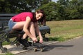 Fun time in sun beautiful girl putting on skates Royalty Free Stock Photo