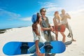 Fun under the desert sun. a group of young friends sandboarding in the desert. Royalty Free Stock Photo