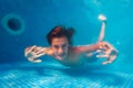 Fun underwater boy poses with hands in the pool Royalty Free Stock Photo