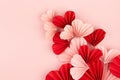 Fun Valentines day festive background in asian style - curved stream of many pink and red paper hearts of folded fans on gentle. Royalty Free Stock Photo